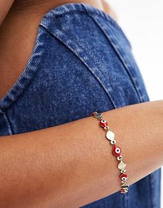 ASOS DESIGN bracelet with red eye bead detail in gold tone | ASOS Design Bracelet, Festival Accessories, Red Eye, Winter Party Dress, Skirt Co Ord, Neck Chain, White Trainers, Black Wrap Dress, Maxi Dress Trend