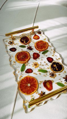 a white tray with oranges and spices on it