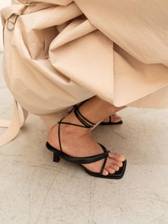 - Square toe- Self-tie strappy sandal- Bold flip flop strap- French mid heelMeasurements- Heel: 2.3- Size: KR225(US5.5)-KR250(US8)- This item is based on the KR shoe size. Please refer to the size chart.- This item runs true to size. For wide feet, please order half size larger than your normal size.Composition & Care- Upper: Sheep leather- Midsole: Sheep Leather- Insole: Synthetic LeatherDesigner- Made in Korea- by CHIELEI- Style#: 300905777 Evening Toe Post Heels With Wrapped Heel, Chic T-strap Sandals With Heel And Toe Post, Chic T-strap Sandals With Heel Strap, Spring Toe Post Sandals With Heel Strap, Spring Toe Ring Sandals With Heel Strap, Evening Toe Post Sandals With Heel Loop, Toe Post Sandals With Heel Strap For Spring, Formal Sandals With Wrapped Heel And Toe Post, Chic Toe Ring Sandals With Heel Strap