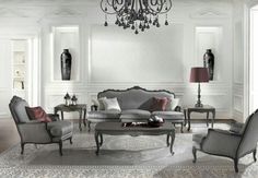 a living room filled with furniture and a chandelier