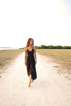 Our stylish, must-have version of the essential LBD (little ​beach dress), the Sage Maxi Dress Black is a flowing asymmetric dream that’s perfect for mid-summer events, beach days, and travel. The silhouette is inspired by the tranquil vibes of Tulum’s beaches and bustling energy of its town center. It features long straps you can wrap twice around the waist for an adjustable fit. Breathable fibers keep you cool as you lounge, explore, and indulge all summer long. - V-neckline- Adjustable straps Black Summer Midi Dress For Beach Season, Black Beachwear Midi Dress For Vacation, Black Midi Dress For Summer Beach Outing, Black Midi Dress For Summer Beach, Black Summer Midi Dress For Beach, Black Midi Beachwear Dress For Summer, Black Summer Midi Dress For Vacation, Summer Asymmetrical Maxi Dress For Beach, Beach Sundress With Asymmetrical Hem