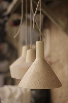 three wooden lamps hanging from the ceiling in a room with text overlay that reads lovely lamps made of wood