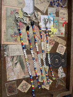 a wooden box filled with lots of different types of bead and button jewelry hanging from it's sides