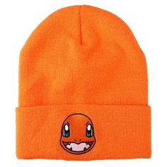 an orange beanie with a face drawn on it