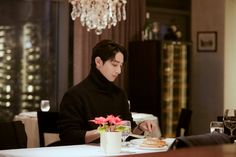 a man sitting at a table with food in front of him