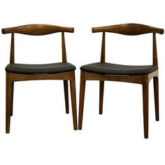 a pair of wooden chairs with black leather seats