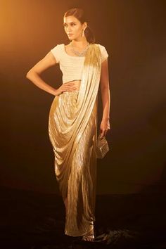 Shop for Tasuvure Indies Beige Pleated Saia Metallic Pre-draped Saree With Blouse for Women Online at Aza Fashions Festive Evening Pre-draped Saree With Zari Work, Elegant Party Pre-draped Saree With Zari Work, Festive Evening Pre-draped Saree With Cutdana, Glamorous Designer Pre-draped Saree For Navratri, Embellished Pre-draped Saree For Diwali Evening, Party Wear Pre-draped Saree With Cutdana, Pre-draped Saree With Pallu For Evening Festivals, Evening Pre-draped Saree With Unstitched Blouse For Navratri, Silk Pre-draped Saree For Navratri Party