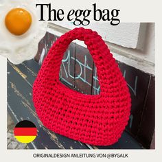 an egg is laying on top of a red handbag with the word, the egg bag written in german