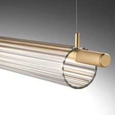 a light fixture hanging from the side of a ceiling with metal rods and gold fittings