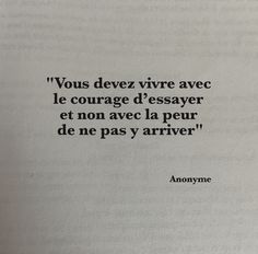 an open book with black writing on the page and a quote written in french above it