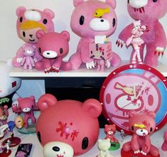 there are many pink teddy bears and other toys on the shelf next to each other