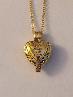 Gold Heart Cremation Urn Necklace.  Heart says, Always In My Heart.  Comes with everything needed to help you get the ashes into the urn at no additional charge.  ** We also carry this necklace in silver. Comes on a 20 inch gold stainless steel chain.  Please feel free to message us with any questions you may have.  Thank you so much. Gold Heart Locket Necklace Spiritual Style, Gold Heart-shaped Spiritual Locket Necklace, Spiritual Gold Heart Locket Necklace, Adjustable Heart Keepsake Necklace, Adjustable Heart Necklace For Keepsake, Adjustable Heart-shaped Keepsake Necklace, Personalized Heart Shaped Spiritual Necklace, Personalized Heart-shaped Spiritual Necklace, Gold Heart Necklace For Memorial