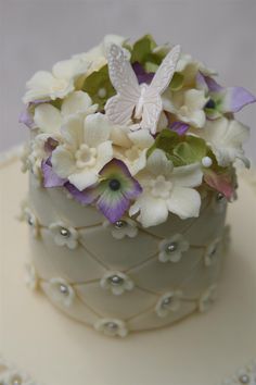 there is a cake decorated with flowers and butterflies