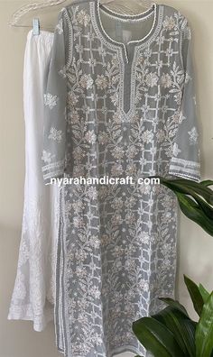 "Beautiful gray hand embroidered Chikankari kurta with gota patti add ons! Team it with Chikankari palazzo and chiffon Dupatta to complete the look! \"Embroidery Designs may vary\" Kurta Length : 48 inches Palazzo Length : 40 inches Elastic waistband: One Size" Embroidered Gray Kurta For Eid, Gray Embroidered Kurta For Eid, Traditional Gray Kurta For Diwali, Festive Gray Embroidered Kurta, Festive Embroidered Gray Kurta, Gray Chikankari Embroidery Traditional Sets, Traditional Gray Chikankari Embroidery Sets, Gray Traditional Sets With Chikankari Embroidery, Traditional Gray Kurta For Wedding