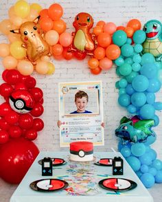 a pokemon birthday party with balloons, decorations and an autographed photo on the table