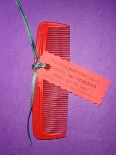 a red comb with a tag attached to it