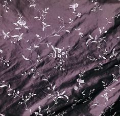 the fabric has white flowers on it and is very dark purple with white outlines