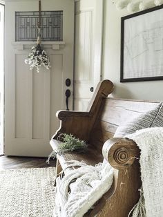 a wooden bench sitting in the middle of a living room next to a white door