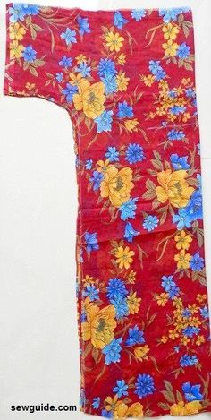 a red and yellow flowered cloth with blue flowers on it's side, hanging from a white wall