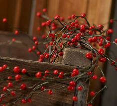 a wooden crate with red berries on it