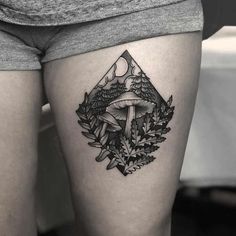 a woman's thigh with a mushroom and leaves tattoo on it