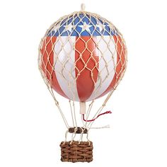 a red, white and blue hot air balloon in a basket on a white background