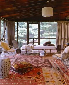 a living room filled with furniture and lots of windows