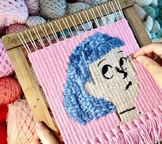 someone is working on an art project with yarn in the shape of a woman's face