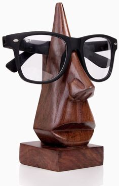 a wooden head with glasses on top of it