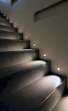 the stairs are lit up with lights on them and there is only one light in the room