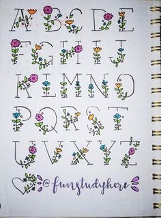 an open notebook with flowers and letters on the pages, all written in cursive writing