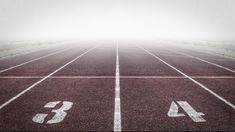 an empty running track with white numbers on it