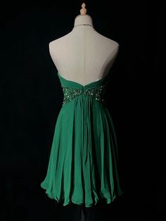 a green dress on a mannequin headdress with beaded waistlines