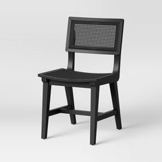 a black chair with an open back and seat made out of wood, on a white background