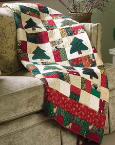 a couch with a christmas tree quilt on it