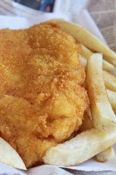 fried fish and french fries on a newspaper