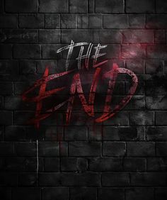 the end on a brick wall with red spray paint and white letters that read, at the end