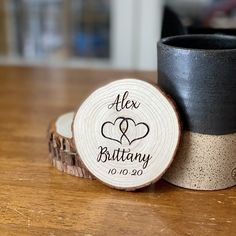 two black cups sitting on top of a wooden table