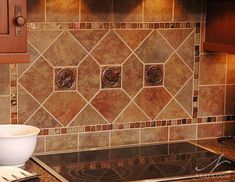 a stove top oven sitting inside of a kitchen next to a counter with a bowl on it