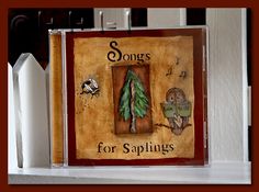 there is a painting on the shelf that says songs for saplings