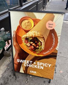 a sign on the sidewalk advertising sweet and spicy chicken quesadilla with sauce