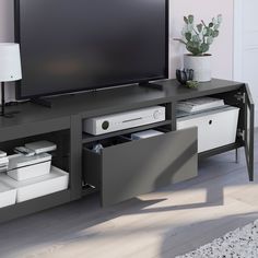 a flat screen tv sitting on top of a black entertainment center