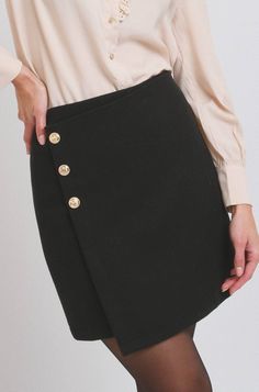 Short black wool skirt High waist 3 gold buttons on right side Straight cut Back zipper With 100% viscose lining Skirt in 35% wool and 65% polyester  Length: 44 cm (for an S and 1 cm longer for each size above) Worn with Enis blouse Emily In Paris Style, Spain Travel Outfits, Black Wool Skirt, Short Black Skirt, Business Skirt, Jeans Overall, Trip Outfits, Skirt High Waist, Wool Skirt