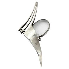 The biomorphic form of this graceful becomes a vehicle for the imagination. The rock crystal and sterling silver combination is clean, pure and airy. There is a feeling of movement here; one of flight. The brooch can be worn vertically or horizontally. To give you a sense of scale, the oval crystal is one inch in width. Diery is the designer and creator of this sculptural jewel. Excellent Condition Spiritual Silver Jewelry Brooch, Ceremonial Hallmarked Pendant Brooch, Silver Oval Hallmarked Brooch, Luxury Modernist Brooches For Gift, Modernist Sterling Silver Brooch, Sterling Silver Brooch, Silver Brooch, Rock Crystal, The Rock