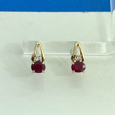 * Designer 14K Yellow Gold Oval Ruby Round Diamond Accented Stud Earrings * Length: 1/2" * Width: 3/16" * Two oval Rubies measure approximately 5.0 mm x 3.0 mm each * Two round Diamonds measure approximately 2.1 mm each * Weight: 1.2 tgw * Marked: 14K * MAKERS MARK * MEXICO * Fastening: Butterfly-INCLUDED * Condition: As pictured. * CN50    Exported By ExportYourStore :) Yellow Gold Oval Earrings With Prong Setting, Classic Oval Pierced Earrings, Formal Oval Earrings Stamped 14k, 14k Gold Oval Earrings With Diamond Cut, Oval Earrings For Anniversary, Hallmarked Oval Diamond Earrings, Oval Diamond Earrings, Red Oval Diamond Earrings For Anniversary, Oval Diamond Cut 14k Gold Earrings