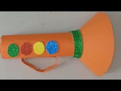 an orange plastic tube with green and yellow decorations