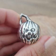 Product Description: Introducing our Sterling Silver Scary Jack-O'-Lantern Pumpkin Ring - the perfect addition to any Halloween fan's collection! This handcrafted ring is made from high-quality 925 silver and features immaculate detail, making it a unique and eye-catching accessory. The anatomically accurate design of the scary jack-o'-lantern pumpkin adds a touch of gothic and punk aesthetic to the ring.  Highlights: - This ring is handmade from 925 silver, making it a durable and long-lasting Gothic Collectible Rings For Halloween, Collectible Gothic Rings For Halloween, Handmade Silver Skull Ring For Halloween, Handmade Sterling Silver Skull Ring For Halloween, Adjustable Halloween Rings, Adjustable Rings For Halloween, Adjustable Halloween Collectible Rings, Unique Skull Ring For Halloween Gift, Unique Halloween Collectible Skull Ring