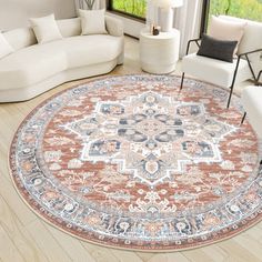 a living room with white couches and a large round rug