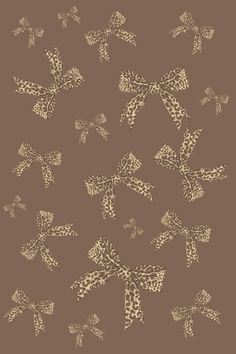 a brown and white pattern with butterflies on the top of it, as well as an image