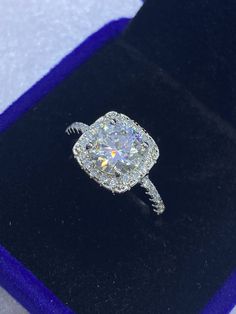 a diamond ring sitting on top of a velvet box